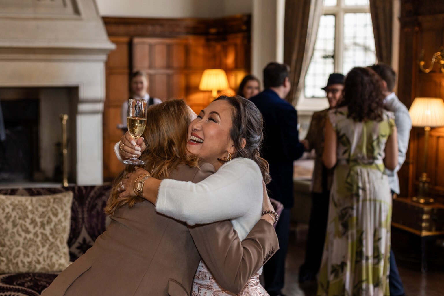 Woman is hugging a friend of hers during Birthday Party at Danesfield House Hotel in Marlow.