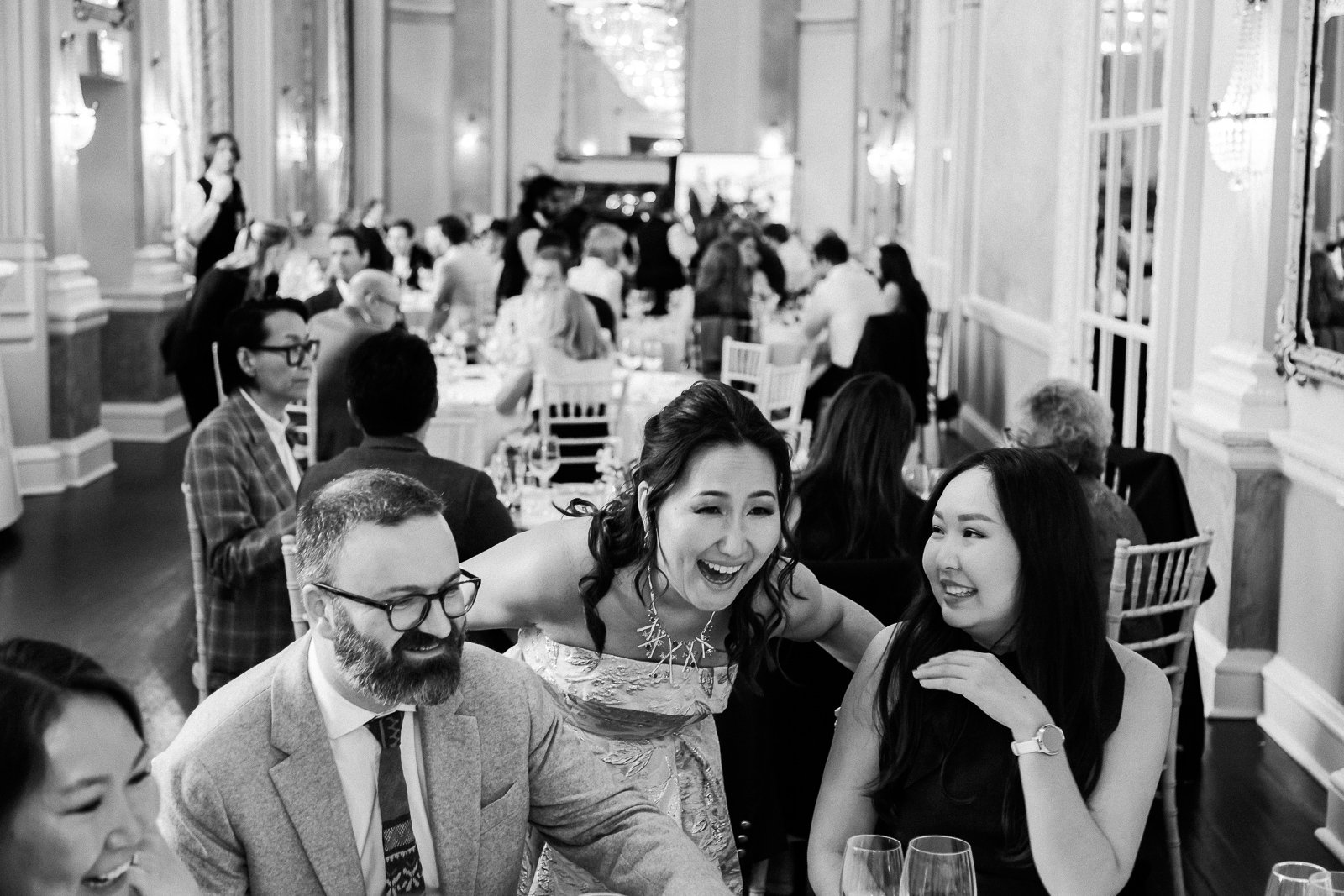 Woman is smiling with her guests during party photography.