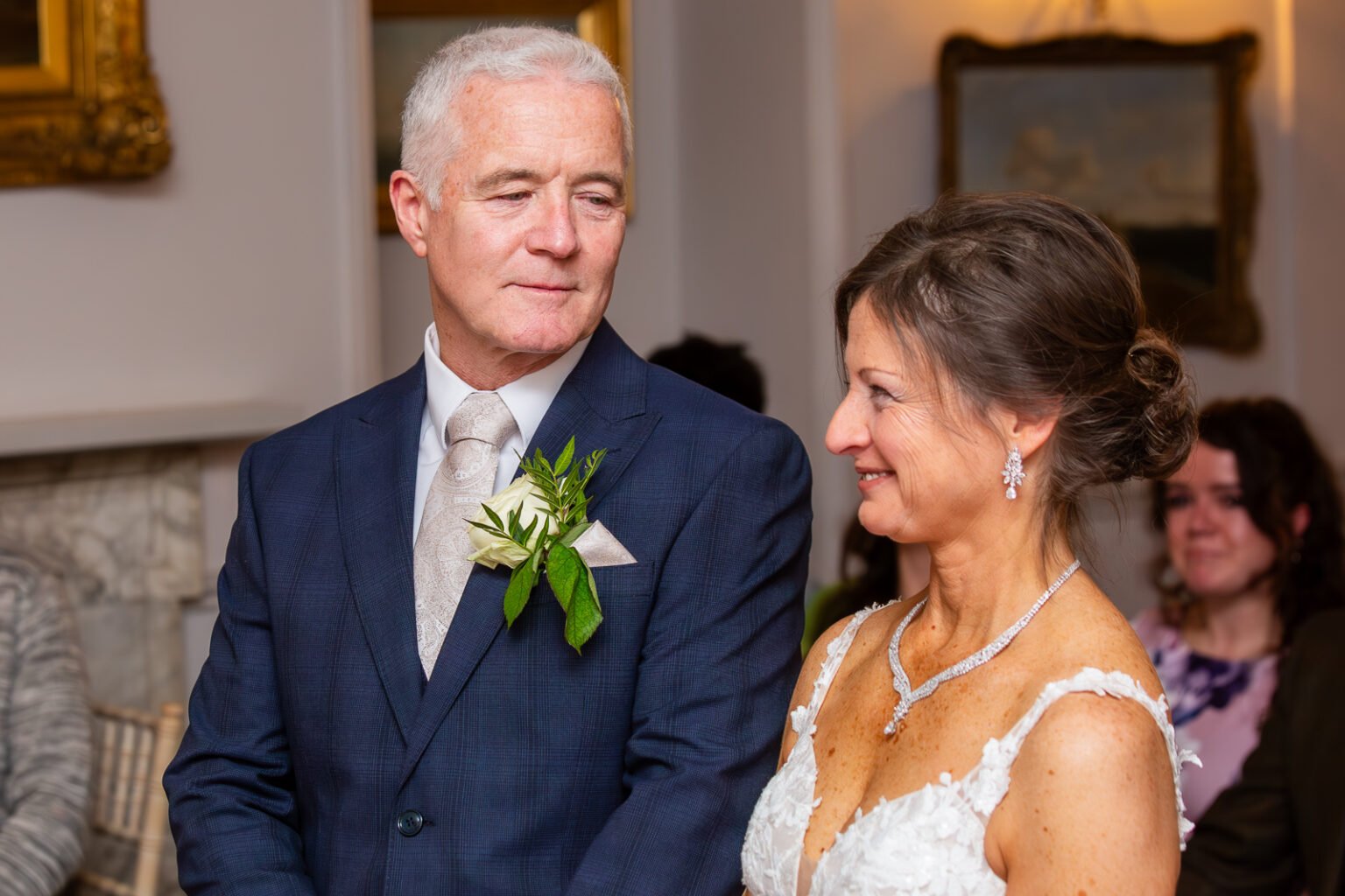 Bride and groom are looking each other at the ceremony in New Place Hotel in Southampton during wedding photography.