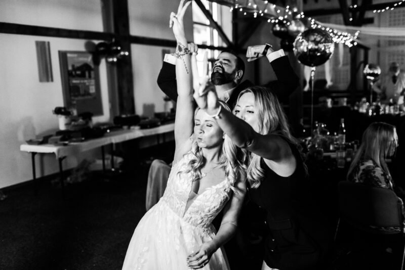 Bride having fun with her guests in the party during wedding photography.