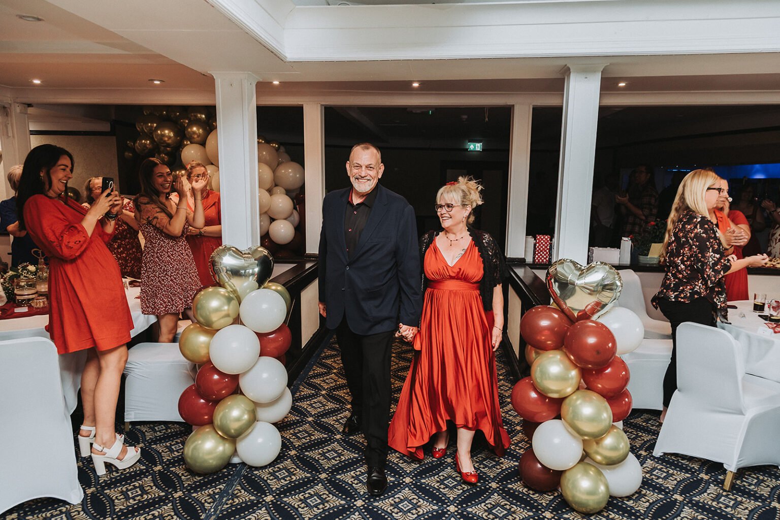 Bride and groom are entering the party area in the Best Western Calcot in Reading during wedding anniversary party photography.