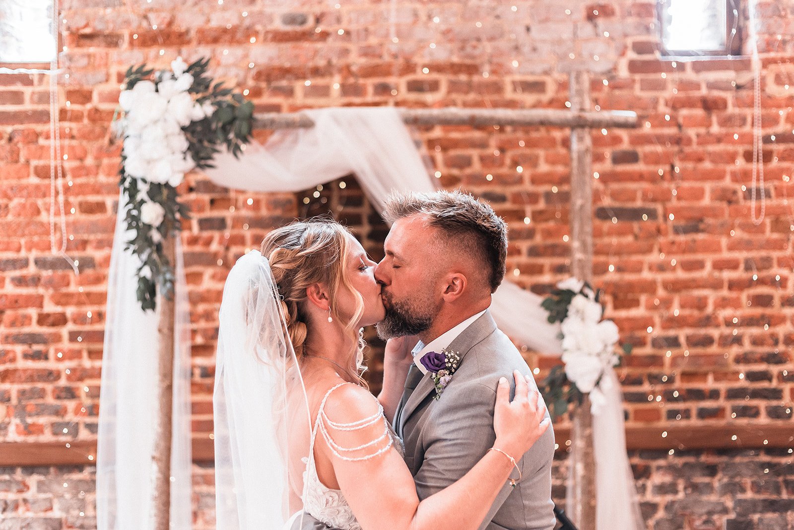Bride and groom kiss each other after the ceremony during wedding photography.