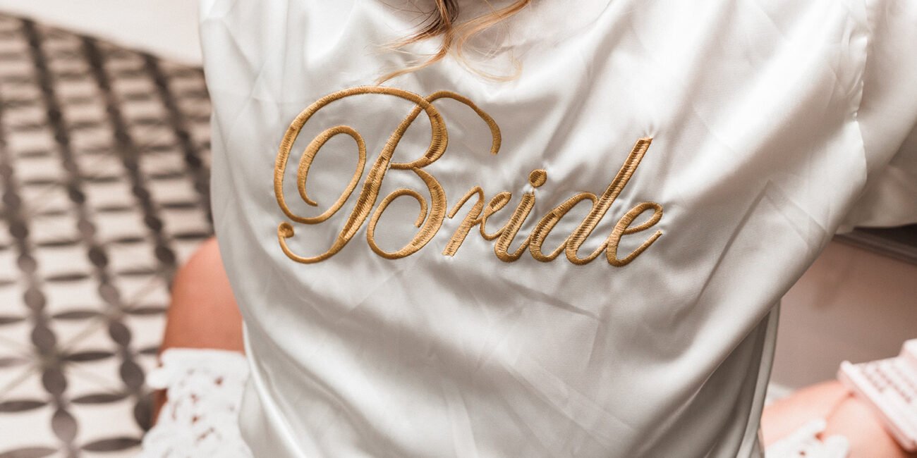Bride sitting in front of the mirror while getting prepared for the wedding during wedding photography.